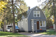 330 E 6TH ST, a Dutch Colonial Revival house, built in New Richmond, Wisconsin in 1920.