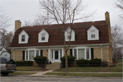 4451-4453 E WILDWOOD AVE, a Dutch Colonial Revival duplex, built in Shorewood, Wisconsin in 1938.