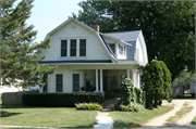 759 N. Madison St., a Dutch Colonial Revival house, built in Lancaster, Wisconsin in 1920.