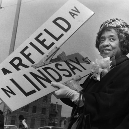 Bernice Lindsay Posing with the Street Sign Named after Her, 1974. Bernice worked as an activist and community leader in Milwaukee.