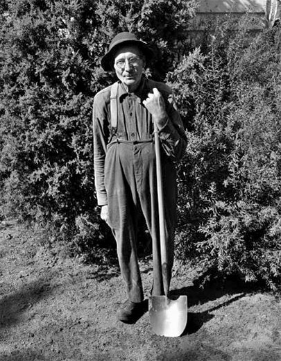 A man holding a shovel in his yard, 1947. WHI 48361.
