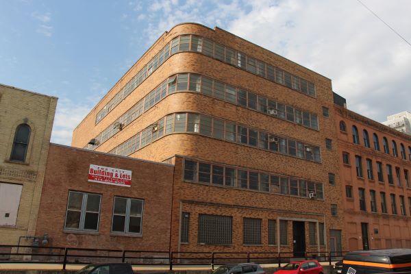 Exterior of Sperry Candy Company, a red brick-like building 