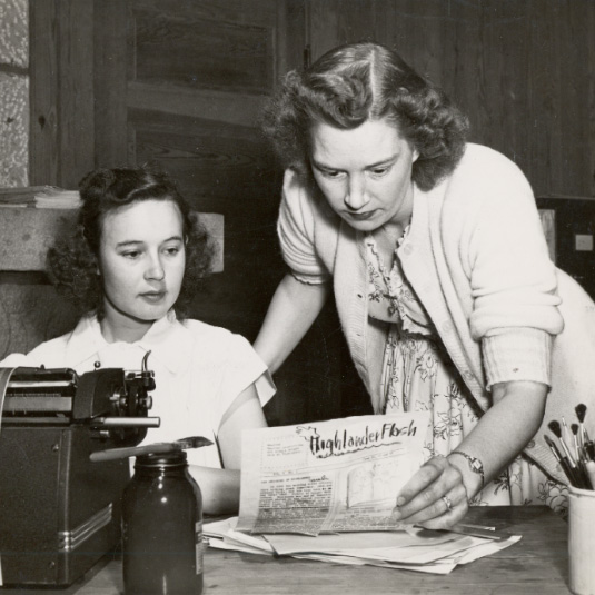 CIO school in the 1940s. Features two women reviewing the "Highlander Flash," a newsletter produced by the Highlander Folk School.