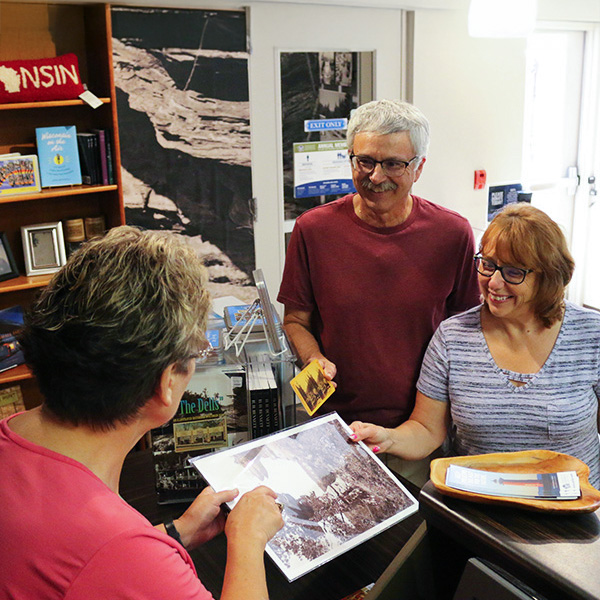 An older couple engaging with an employee at H.H.Bennett studio 