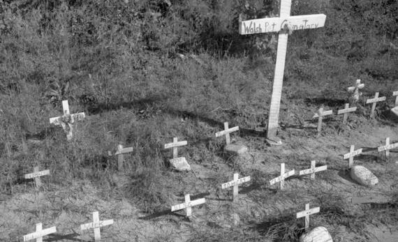 A cemetery for pets near Highway 58. Each burial plot is marked with a small wooden cross