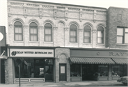 208-210 E MAIN ST, a Romanesque Revival large retail building, built in Watertown, Wisconsin in 1864.