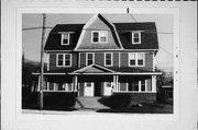 1201-03 S 10TH ST, a Dutch Colonial Revival duplex/two-flat, built in Manitowoc, Wisconsin in 1917.