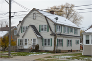 634 RACINE ST, a Dutch Colonial Revival duplex/two-flat, built in Menasha, Wisconsin in 1937.