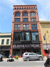 116 S 4TH ST, a Romanesque Revival retail building, built in La Crosse, Wisconsin in 1884.