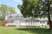 1404 MICHIGAN AVE, a Dutch Colonial Revival house, built in Manitowoc, Wisconsin in 1905.