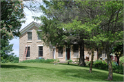 76 US Highway 14, a Gabled Ell house, built in Rutland, Wisconsin in 1850.