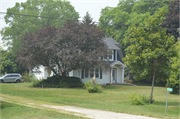 N4572 STH 57, a Dutch Colonial Revival house, built in Lyndon, Wisconsin in 1920.