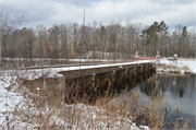 Wozny Road (abandoned) over Totagatic River, a NA (unknown or not a building) dam, built in Frog Creek, Wisconsin in 1953.