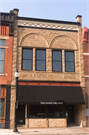 1136 MAIN ST, a Romanesque Revival small retail building, built in Stevens Point, Wisconsin in 1900.