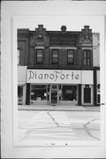 913-925 MAIN ST, a Romanesque Revival retail building, built in Stevens Point, Wisconsin in 1885.