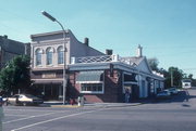 180-184 E MAIN ST, a Romanesque Revival small retail building, built in Stoughton, Wisconsin in 1876.