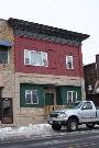 113 W PULASKI ST, a Commercial Vernacular small retail building, built in Pulaski, Wisconsin in 1900.