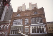 725-729 N MILWAUKEE ST, a Queen Anne large retail building, built in Milwaukee, Wisconsin in 1881.