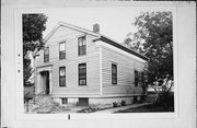 910 S 3RD ST, a Greek Revival house, built in Milwaukee, Wisconsin in 1854.