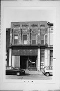 711-713 S 5TH ST, a Romanesque Revival small retail building, built in Milwaukee, Wisconsin in 1888.