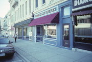 117-119 W MILWAUKEE ST, a Commercial Vernacular small retail building, built in Janesville, Wisconsin in 1869.