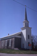 ON BUSS ROAD, ONE BLOCK S OF SHOPIERE RD, a Greek Revival house of worship, built in Turtle, Wisconsin in 1850.