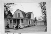 408 S 1ST ST, a Dutch Colonial Revival house, built in Evansville, Wisconsin in 1900.