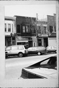 21 N MAIN ST, a Queen Anne retail building, built in Janesville, Wisconsin in 1855.