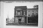 117 N MAIN ST, a Queen Anne retail building, built in Janesville, Wisconsin in 1858.