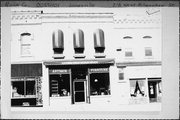 218 W MILWAUKEE ST, a Commercial Vernacular small retail building, built in Janesville, Wisconsin in 1876.