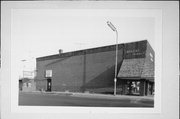 255 S KNOWLES AVE, a Commercial Vernacular small retail building, built in New Richmond, Wisconsin in 1912.