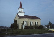 N SIDE OF TOWN LINE RD .1 M E OF CHAPEL DR, E SHORE OF WHITEWATER LAKE, a Greek Revival house of worship, built in Whitewater, Wisconsin in 1855.