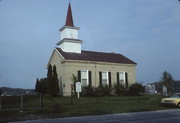 N SIDE OF TOWN LINE RD .1 M E OF CHAPEL DR, E SHORE OF WHITEWATER LAKE, a Greek Revival church, built in Whitewater, Wisconsin in 1855.