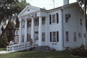 229 WISCONSIN AVE, a Greek Revival house, built in Waukesha, Wisconsin in 1842.