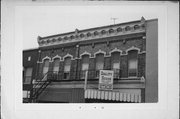 320-328 W BROADWAY AVE, a Italianate large retail building, built in Waukesha, Wisconsin in 1890.