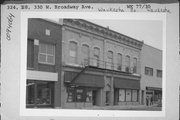 320-328 W BROADWAY AVE, a Italianate large retail building, built in Waukesha, Wisconsin in 1890.
