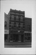 23 N MAIN ST, a Romanesque Revival small retail building, built in Oshkosh, Wisconsin in 1873.