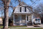 408 S 1ST ST, a Dutch Colonial Revival house, built in Evansville, Wisconsin in 1900.