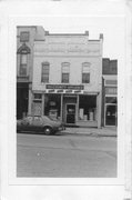 115 S MAIN ST, a Commercial Vernacular small retail building, built in Oregon, Wisconsin in 1877.
