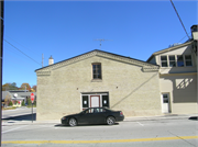 SE CORNER OF BUFFALO AND MONROE, a Greek Revival large retail building, built in Sheboygan Falls, Wisconsin in .