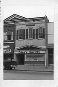 139 E MAIN ST, a Commercial Vernacular small retail building, built in Stoughton, Wisconsin in 1889.