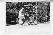 716 PARK ST, a Dutch Colonial Revival house, built in Stoughton, Wisconsin in 1935.