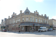 225-227 E MILL ST, a German Renaissance Revival retail building, built in Plymouth, Wisconsin in 1889.