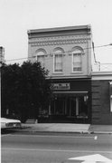 180-184 E MAIN ST, a Romanesque Revival small retail building, built in Stoughton, Wisconsin in 1876.