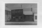 130 MADISON AVE, a Commercial Vernacular small retail building, built in Grantsburg, Wisconsin in 1872.