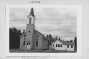 COUNTY HIGHWAY B/E ON SE SIDE OF HAYWARD, HISTORYLAND, OLD HAYWARD, a Front Gabled house of worship, built in Hayward, Wisconsin in 1897.