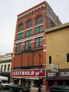 116 S 4TH ST, a Romanesque Revival retail building, built in La Crosse, Wisconsin in 1884.