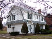 716 PARK ST, a Dutch Colonial Revival house, built in Stoughton, Wisconsin in 1935.