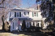 716 PARK ST, a Dutch Colonial Revival house, built in Stoughton, Wisconsin in 1935.