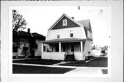 607 - 609 N MAPLE AVE, a Dutch Colonial Revival duplex/two-flat, built in Green Bay, Wisconsin in 1909.